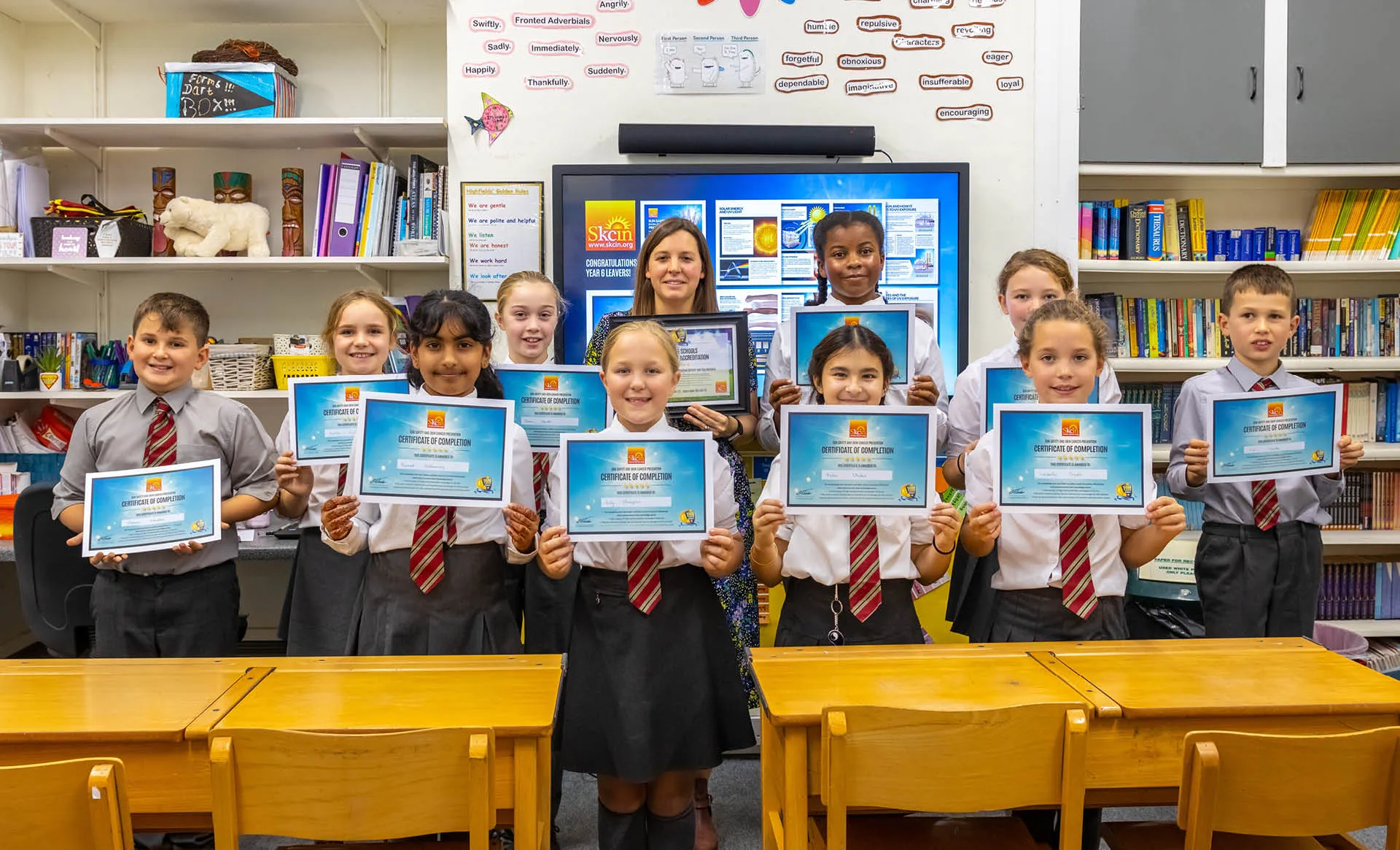 Children holding certificates.
